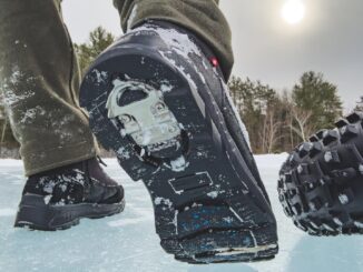 Low angle from behind of Nexgrip boots walking past studded fat bike tire.