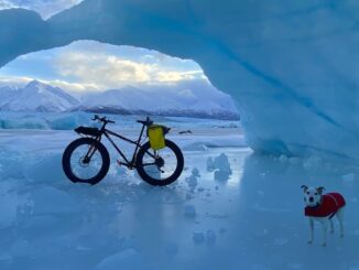 Fatbike and Jack Russell Terrier photographed by ice arch at the Knick Glacier