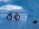 Fatbike and Jack Russell Terrier photographed by ice arch at the Knick Glacier