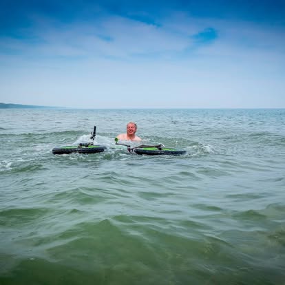 Man swims in Lake Michigan next to floating fat bike