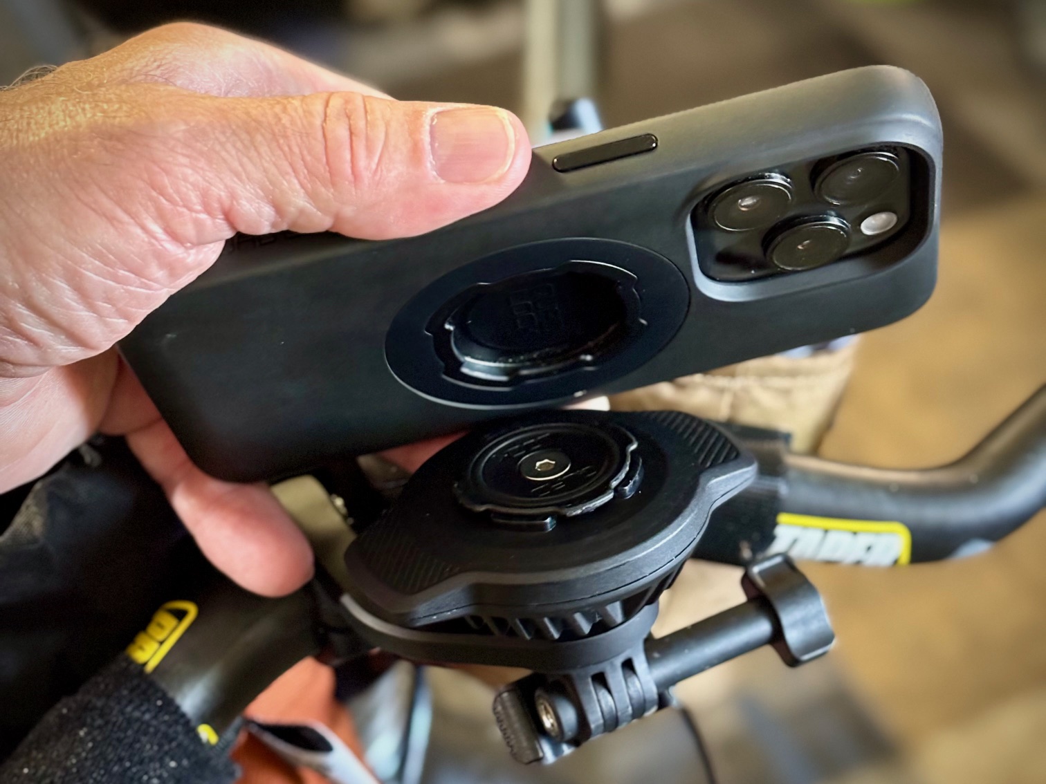 Quad Lock Waterproof Wireless Charger mounted on Out Front Pro handlebar mount with waterproof cable connected to power bank