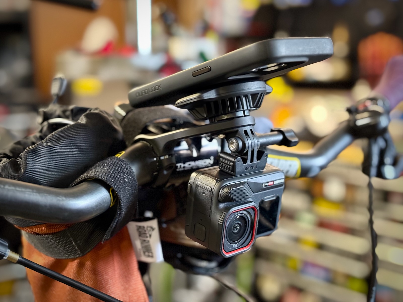 Quad Lock Out Front Pro mount with optional action camera attachment and iPhone in portrait orientatio